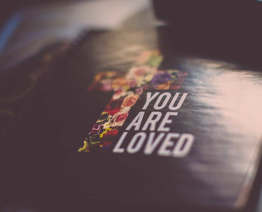 Open Bible with a floral cross and the words You Are Loved